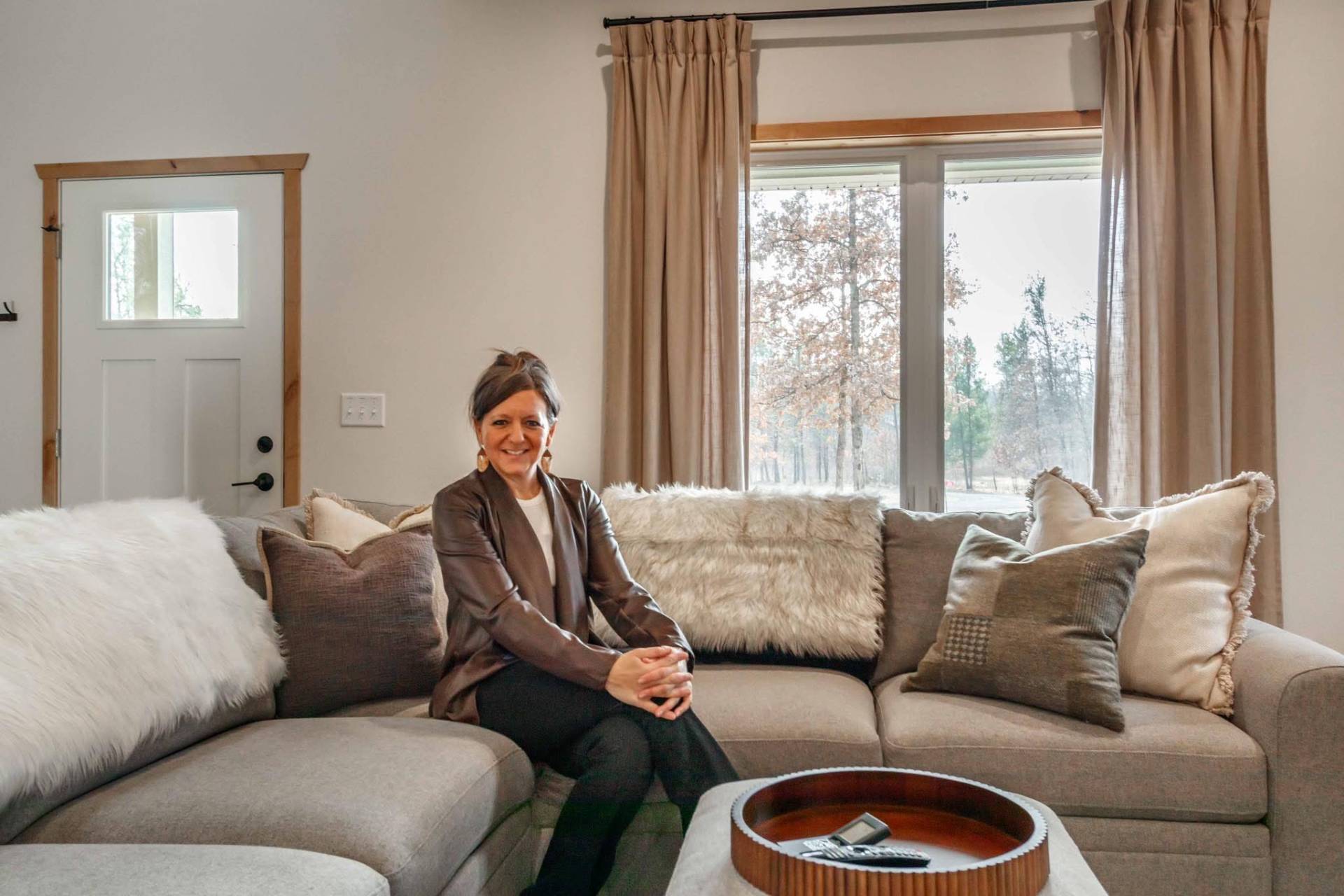 Ash seated in a designed living room